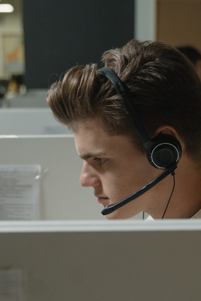 Boy in black headphones looking at the computer